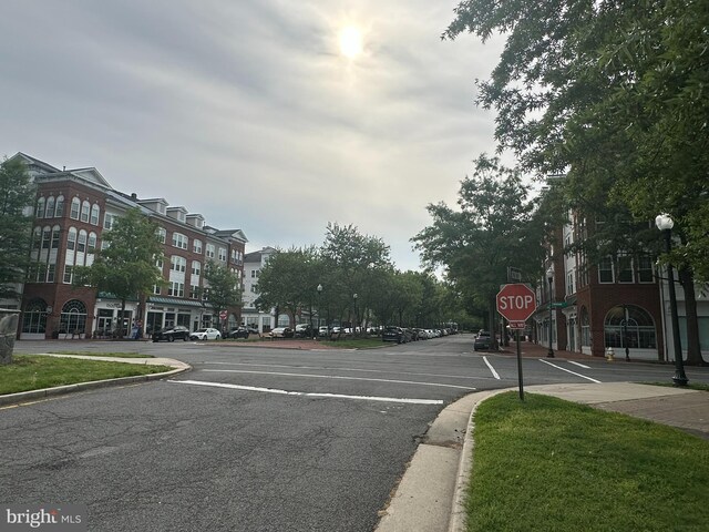 4906 Donovan Dr, Alexandria, VA 22304 - view of asphalt road featuring traffic signs, curbs, sidewalks, and street lights