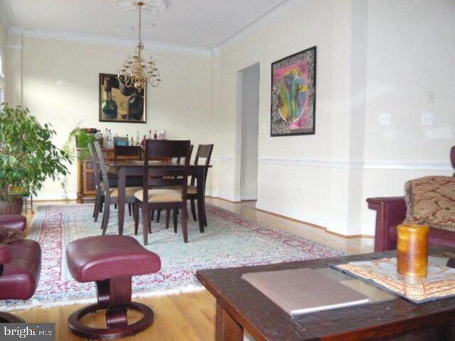 4906 Donovan Dr, Alexandria, VA 22304 - dining area with a chandelier, ornamental molding, and wood finished floors