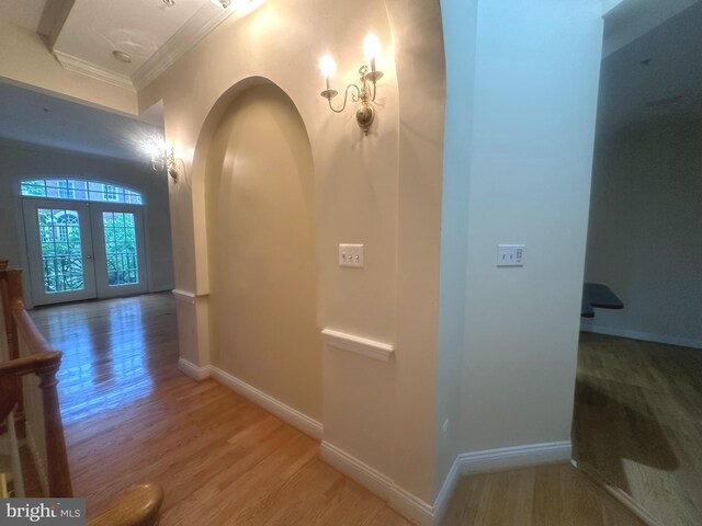 4906 Donovan Dr, Alexandria, VA 22304 - corridor with ornamental molding, light wood-type flooring, french doors, baseboards, and arched walkways