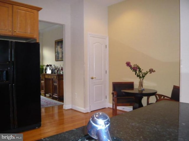 dining area with baseboards and wood finished floors