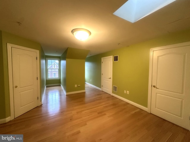 4906 Donovan Dr, Alexandria, VA 22304 - bonus room with light wood-style floors, baseboards, and a skylight