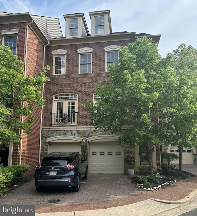 4906 Donovan Dr, Alexandria, VA 22304 - townhome / multi-family property with decorative driveway, an attached garage, stone siding, and brick siding