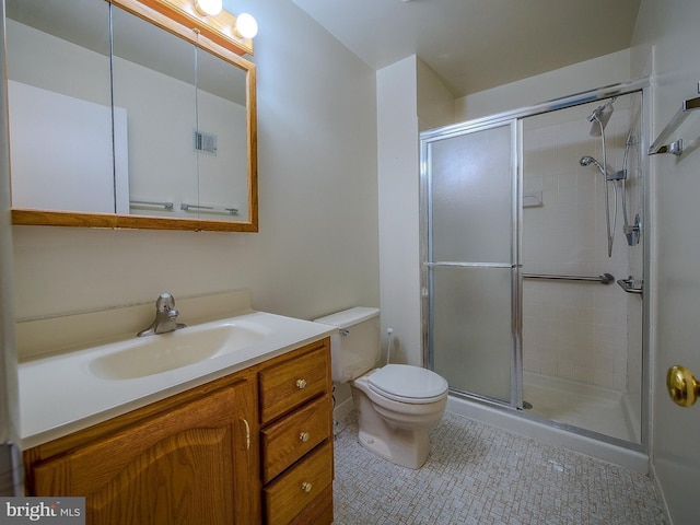 full bath with vanity, toilet, tile patterned flooring, and a stall shower