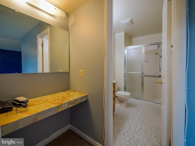 bathroom featuring vanity, toilet, a shower stall, and visible vents