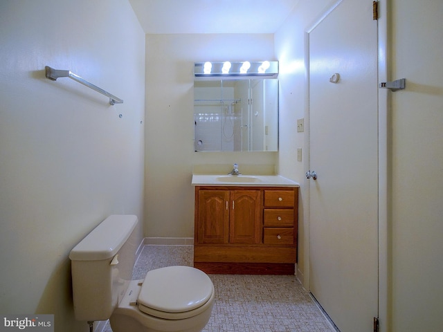 full bathroom featuring walk in shower, toilet, baseboards, and vanity