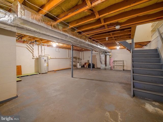 unfinished below grade area with stairway, heating unit, and electric water heater
