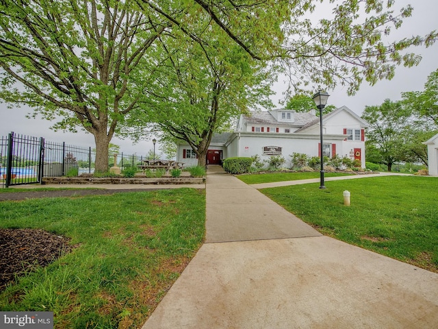 view of front facade featuring fence and a front yard
