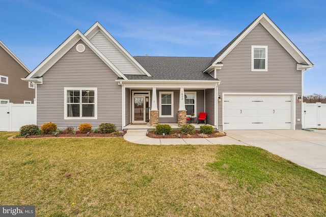 view of front facade with covered porch, driveway, a gate, fence, and an attached garage