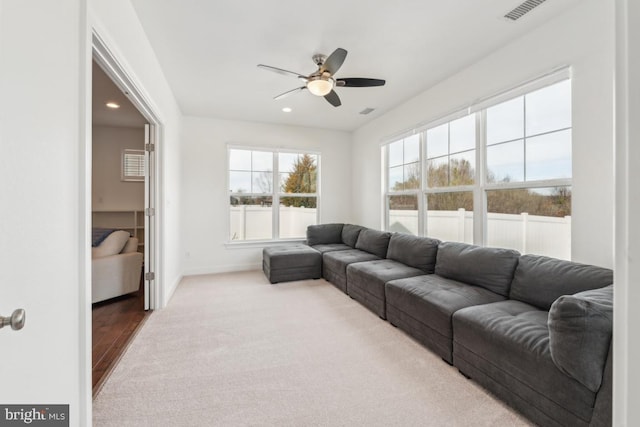 living area featuring a ceiling fan, visible vents, baseboards, carpet floors, and recessed lighting