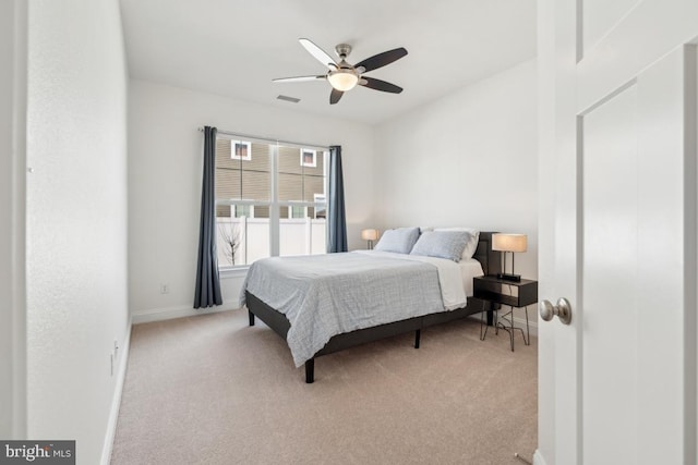 carpeted bedroom with baseboards, visible vents, and ceiling fan