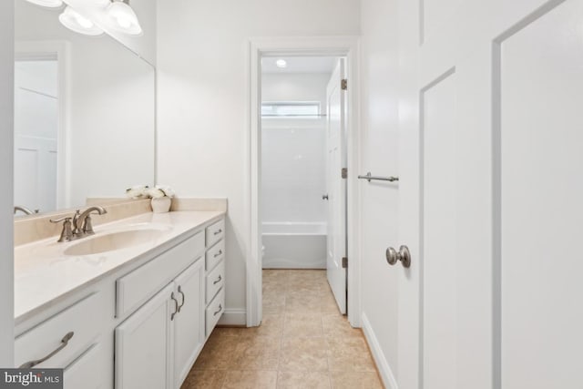 full bath with baseboards, tile patterned flooring, and vanity