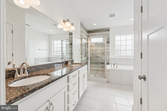 full bath featuring a sink, tile patterned floors, a shower stall, and double vanity