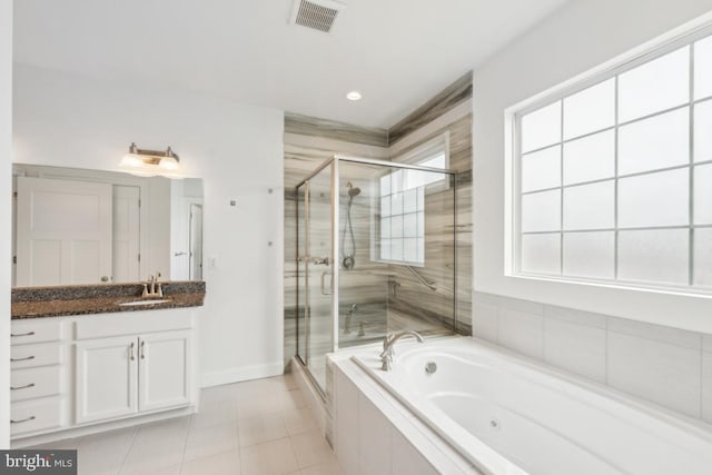 full bathroom featuring a jetted tub, vanity, a stall shower, and visible vents