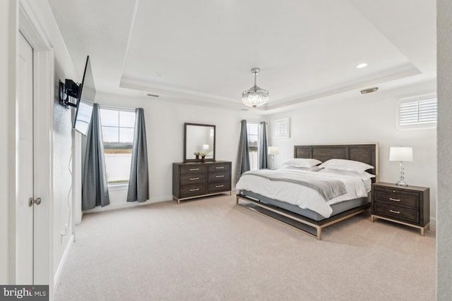 carpeted bedroom with baseboards, recessed lighting, and a raised ceiling