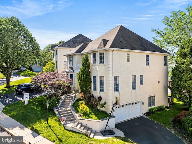 view of home's exterior with a garage, asphalt driveway, stairs, stucco siding, and a shingled roof