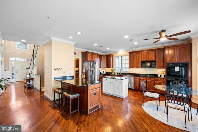 kitchen featuring black appliances, crown molding, dark countertops, dark wood-type flooring, and ceiling fan