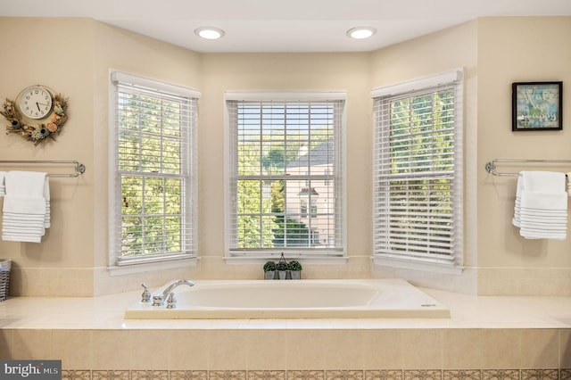 full bathroom with plenty of natural light and a garden tub