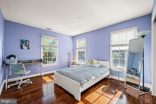 bedroom featuring baseboards and wood finished floors