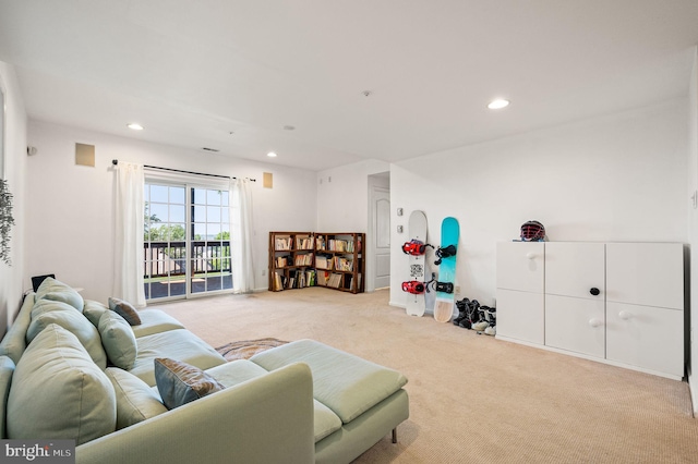 living area with light colored carpet and recessed lighting