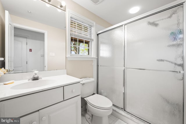 full bathroom featuring a shower stall, tile patterned flooring, vanity, and toilet