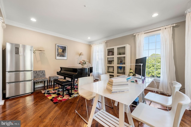 dining room featuring wood finished floors, ornamental molding, and recessed lighting