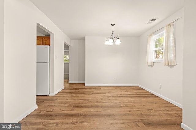 15 Warren Lodge Ct Unit 1D, Cockeysville, MD 21030 - unfurnished dining area with healthy amount of natural light, a chandelier, and light wood-type flooring