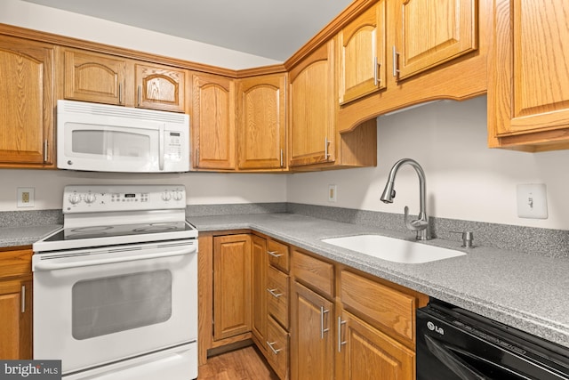 15 Warren Lodge Ct Unit 1D, Cockeysville, MD 21030 - kitchen with white appliances, light wood-type flooring, light countertops, and brown cabinetry