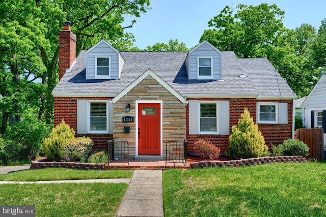 cape cod-style house with a chimney, a front yard, brick siding, fence, and stone siding