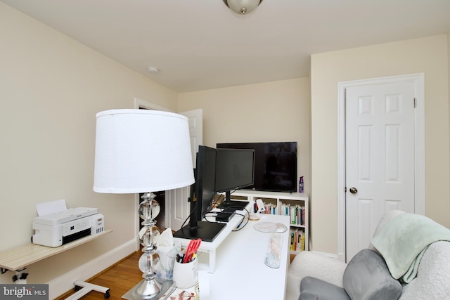 office space featuring baseboards and wood finished floors