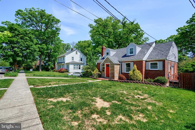 bungalow featuring brick siding, a shingled roof, a chimney, and a front lawn
