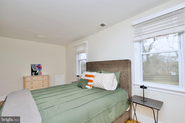 bedroom with baseboards and visible vents