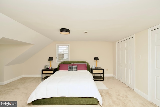 bedroom featuring vaulted ceiling, baseboards, carpet flooring, and visible vents