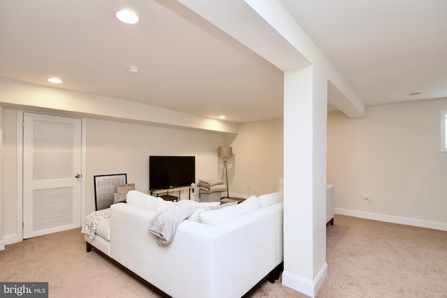 living room featuring baseboards, light carpet, and recessed lighting