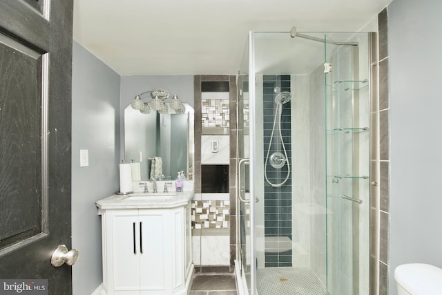full bath featuring vanity, tile patterned floors, a stall shower, and toilet
