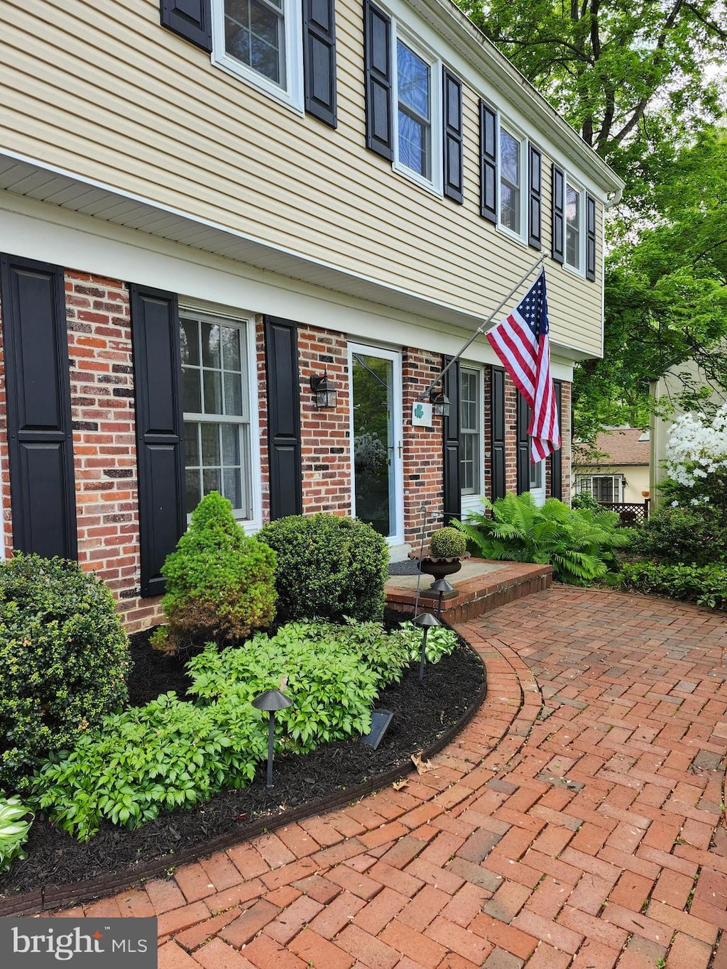 entrance to property featuring brick siding