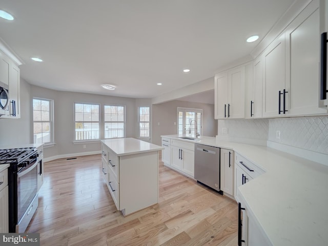 kitchen featuring appliances with stainless steel finishes, light wood-style floors, recessed lighting, and plenty of natural light