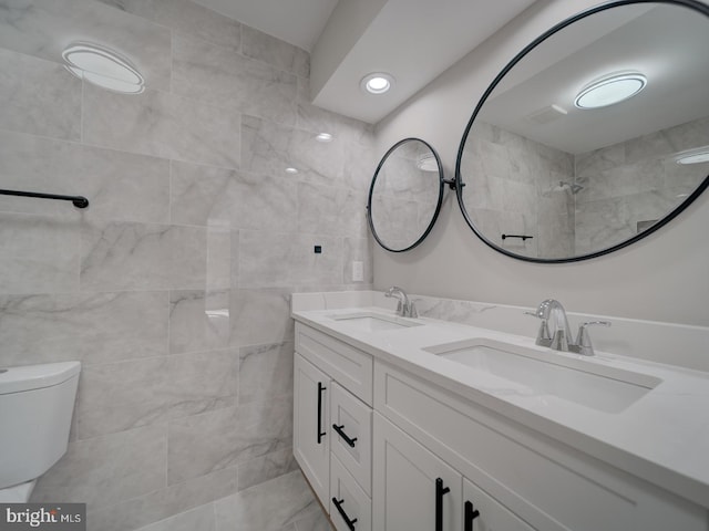 full bathroom featuring toilet and double vanity