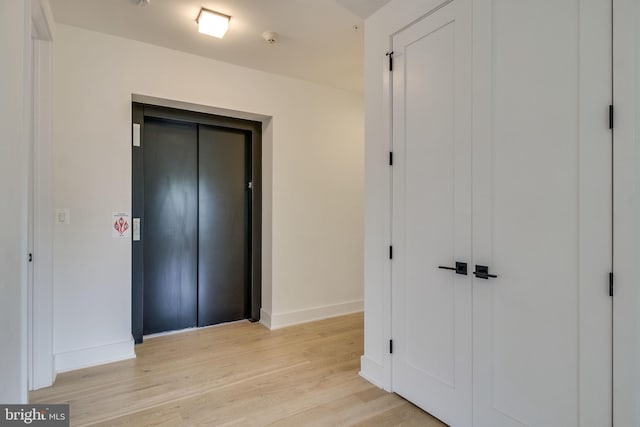 521 N Washington St Unit 201, Alexandria, VA 22314 - hall with elevator, baseboards, and light wood-style floors