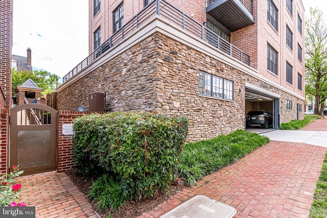 521 N Washington St Unit 201, Alexandria, VA 22314 - exterior space featuring brick siding, a gate, and stone siding