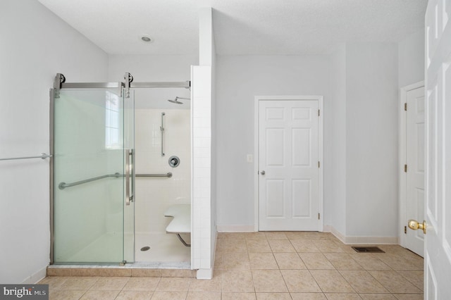 9129 Pebble Beach Ln, King George, VA 22485 - bathroom with a shower stall, tile patterned flooring, and baseboards