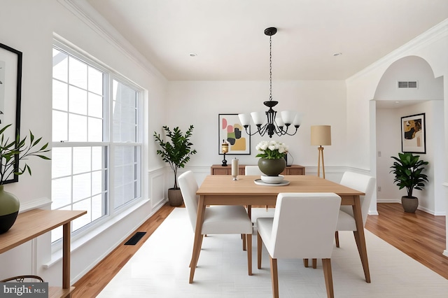 9129 Pebble Beach Ln, King George, VA 22485 - dining room with light wood-type flooring and a chandelier