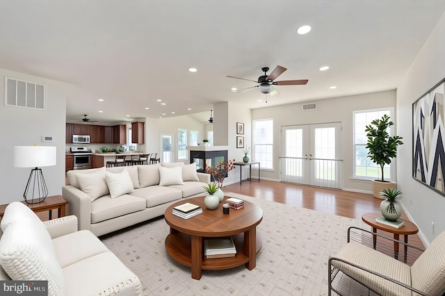 9129 Pebble Beach Ln, King George, VA 22485 - living room featuring ceiling fan, french doors, plenty of natural light, light wood-type flooring, and recessed lighting