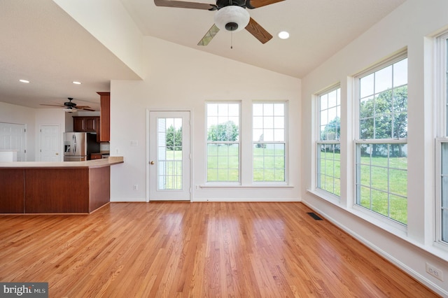9129 Pebble Beach Ln, King George, VA 22485 - kitchen with stainless steel fridge with ice dispenser, a ceiling fan, light wood finished floors, baseboards, and vaulted ceiling