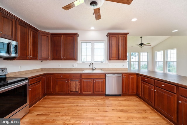 9129 Pebble Beach Ln, King George, VA 22485 - kitchen featuring appliances with stainless steel finishes, a ceiling fan, a sink, plenty of natural light, and a textured ceiling