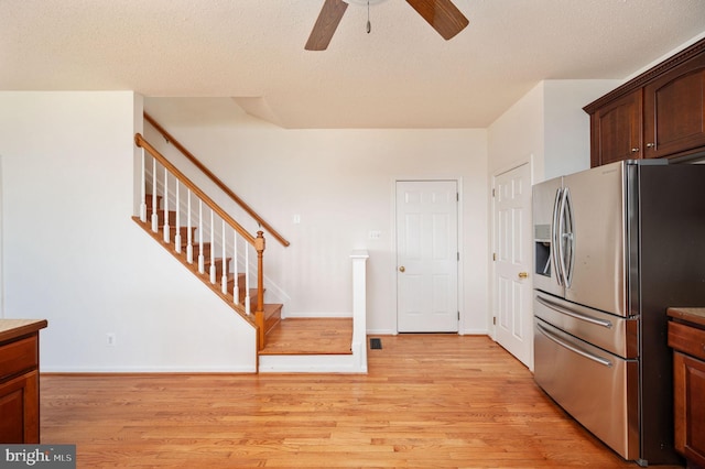 9129 Pebble Beach Ln, King George, VA 22485 - kitchen featuring stainless steel refrigerator with ice dispenser, light wood-style flooring, a ceiling fan, and baseboards
