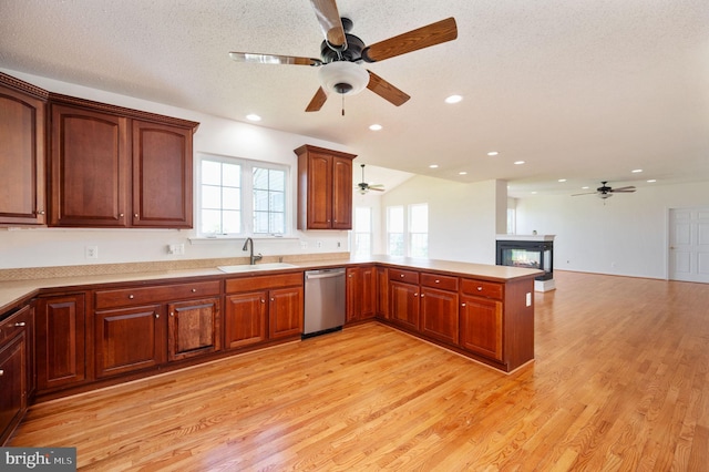 9129 Pebble Beach Ln, King George, VA 22485 - kitchen featuring dishwasher, a sink, a ceiling fan, light wood-style flooring, and a peninsula
