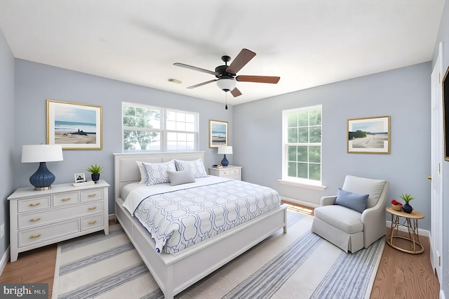 9129 Pebble Beach Ln, King George, VA 22485 - bedroom with baseboards, light wood finished floors, and a ceiling fan