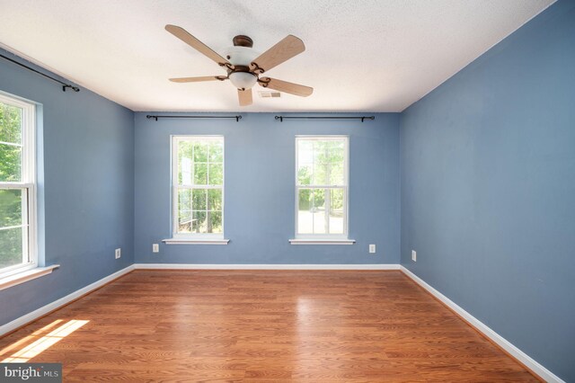 9129 Pebble Beach Ln, King George, VA 22485 - empty room featuring wood finished floors, a ceiling fan, and baseboards