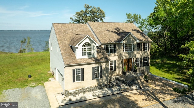 9129 Pebble Beach Ln, King George, VA 22485 - colonial house featuring a water view, roof with shingles, a front yard, and a garage