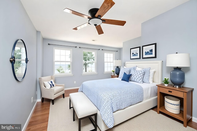 9129 Pebble Beach Ln, King George, VA 22485 - bedroom with baseboards, wood finished floors, and a ceiling fan